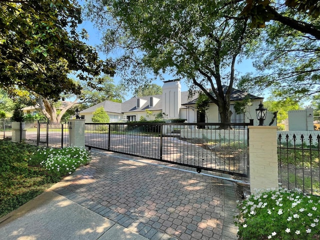 view of gate featuring a fenced front yard and a residential view