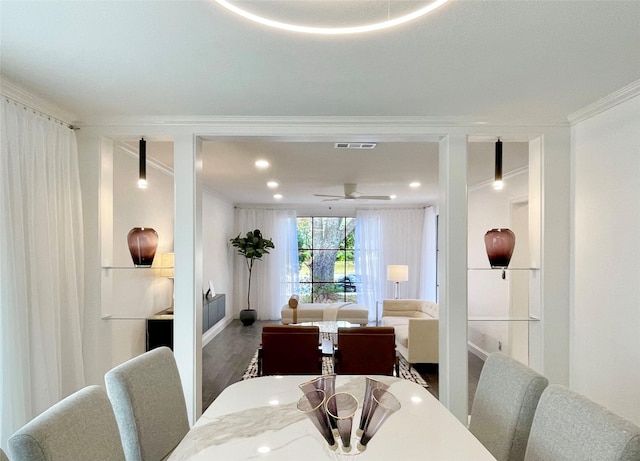 dining area featuring hardwood / wood-style floors, ceiling fan, and ornamental molding