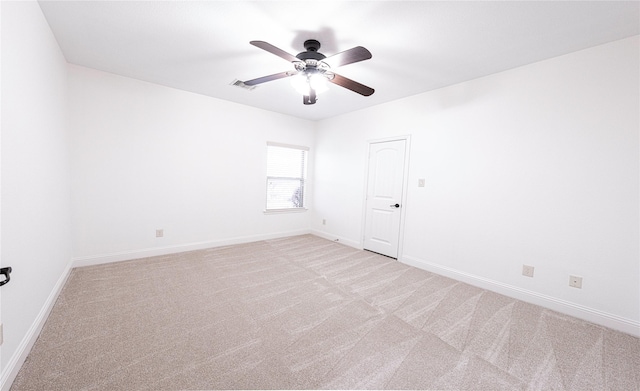 unfurnished room featuring light colored carpet and ceiling fan