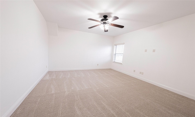 unfurnished room with light colored carpet and ceiling fan