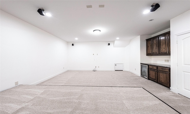 interior space featuring beverage cooler and light carpet