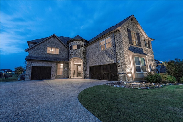 french country inspired facade with a garage and a lawn