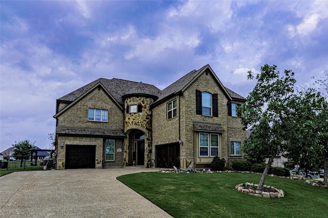 view of front facade with a front yard and a garage