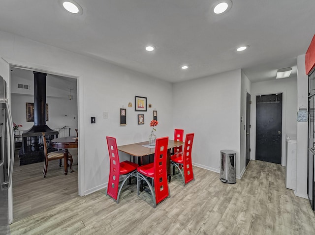 dining space with light hardwood / wood-style floors