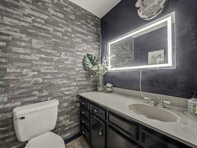 bathroom featuring hardwood / wood-style flooring, vanity, and toilet