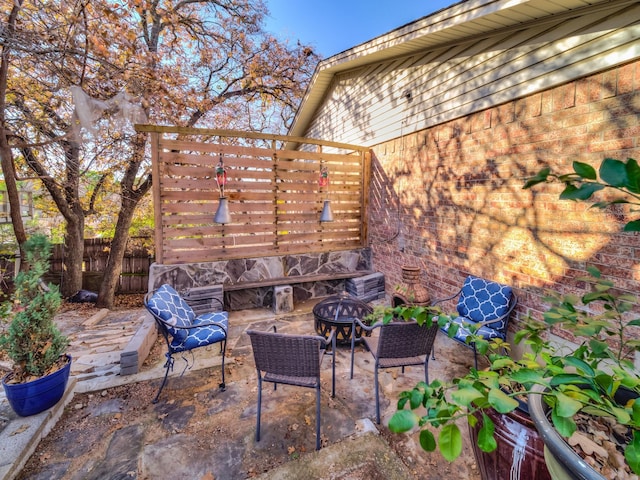 view of patio / terrace featuring an outdoor fire pit