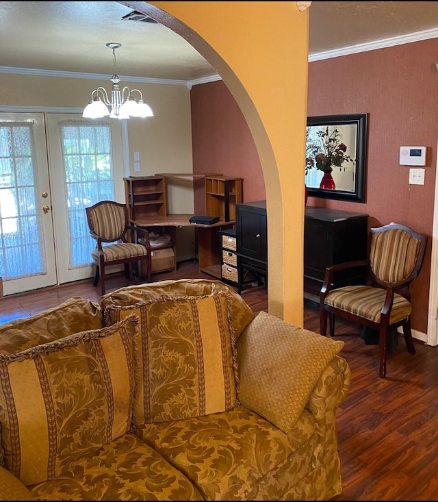 living room with french doors, crown molding, a notable chandelier, and hardwood / wood-style floors