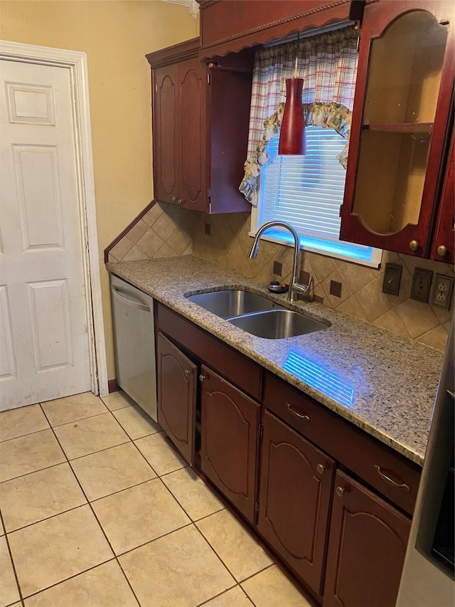 kitchen featuring dishwasher, light tile patterned floors, backsplash, and sink