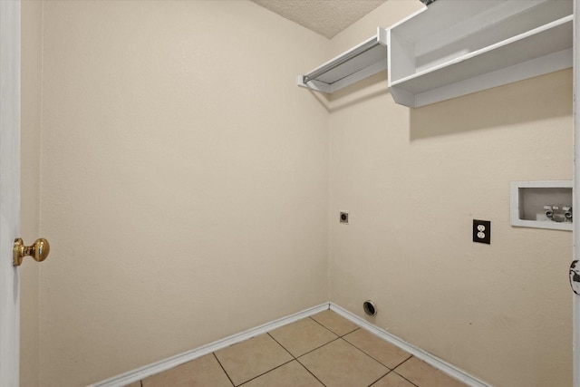 washroom with hookup for a washing machine, electric dryer hookup, tile patterned floors, and a textured ceiling