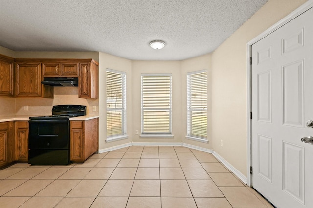 kitchen featuring black range with electric cooktop, a textured ceiling, and light tile patterned floors