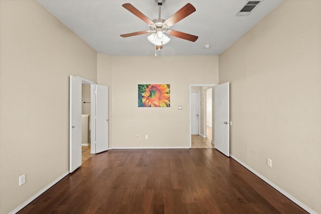 spare room with hardwood / wood-style flooring and ceiling fan