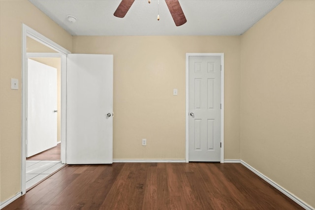 unfurnished bedroom featuring hardwood / wood-style floors and ceiling fan