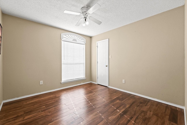 unfurnished room with ceiling fan, dark wood-type flooring, and a textured ceiling