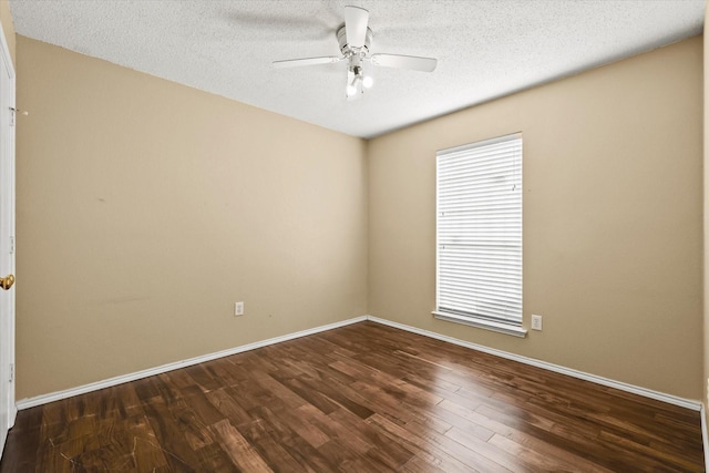 empty room featuring dark wood-type flooring, a textured ceiling, and ceiling fan