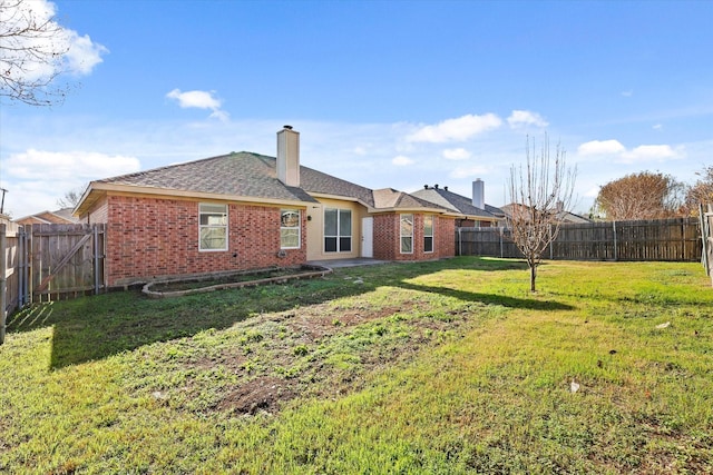 rear view of house with a lawn