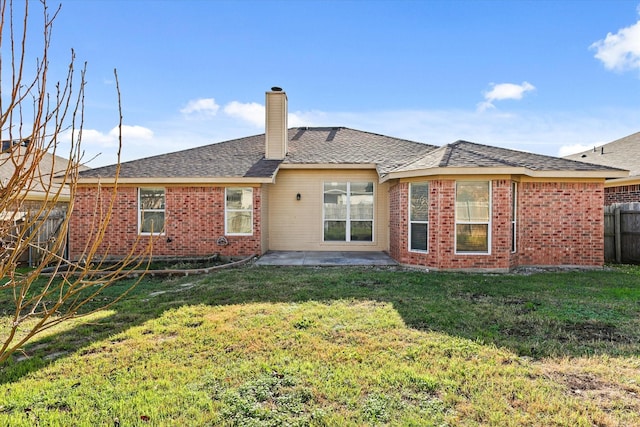 rear view of house featuring a yard and a patio area