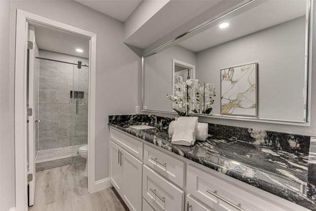 5503 Pecan Grove Dr, Sachse, TX 75048 - full bath with a stall shower, wood finished floors, toilet, vanity, and recessed lighting
