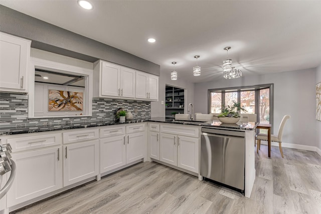 kitchen featuring white cabinetry, pendant lighting, stainless steel dishwasher, and sink