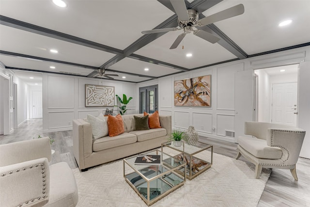 living room featuring beam ceiling, light hardwood / wood-style flooring, ceiling fan, and coffered ceiling