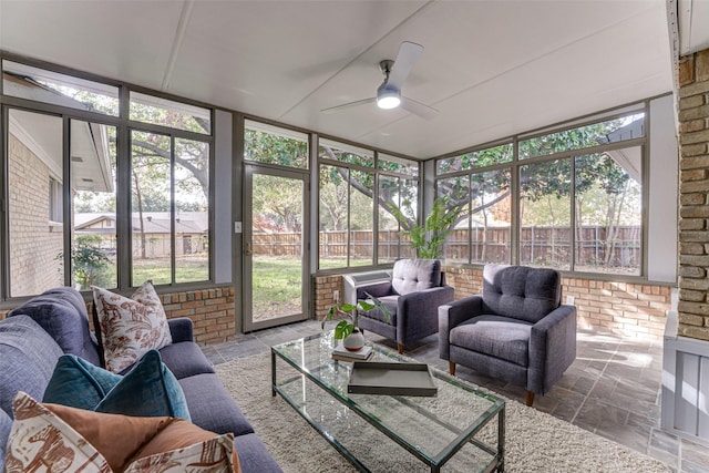 sunroom / solarium featuring ceiling fan