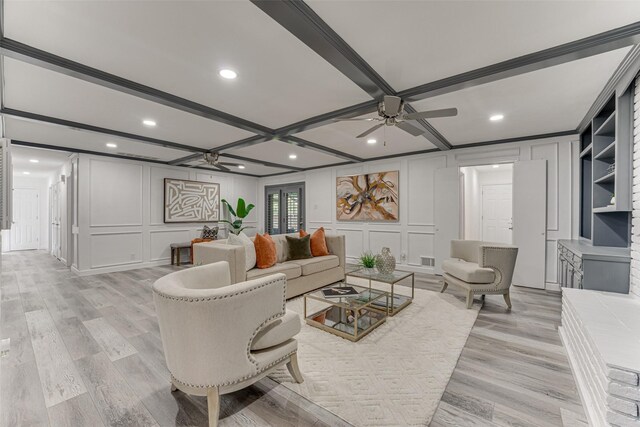 living room with ceiling fan, crown molding, and light hardwood / wood-style floors