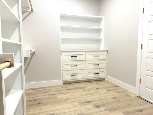 spacious closet with light hardwood / wood-style floors