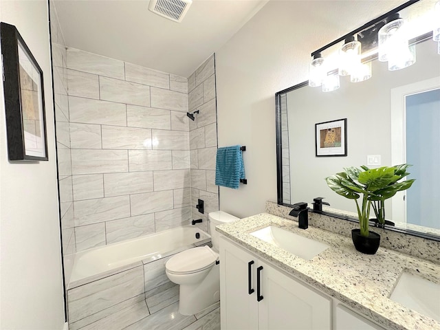 full bathroom with vanity, toilet, and tiled shower / bath