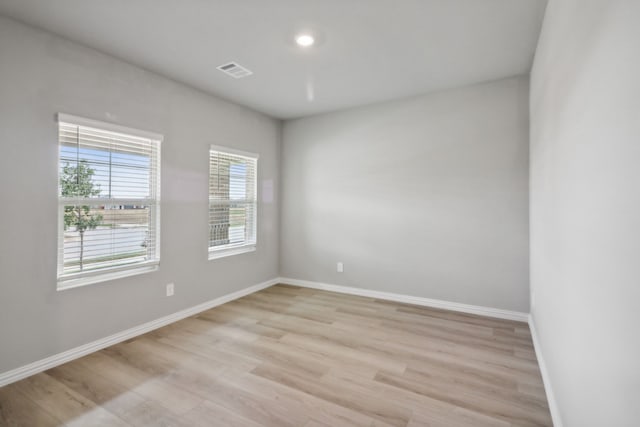 spare room with light hardwood / wood-style flooring