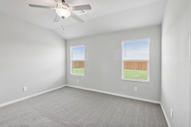 carpeted spare room with ceiling fan and lofted ceiling