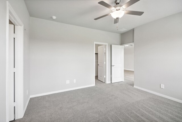 unfurnished bedroom with ceiling fan and light colored carpet