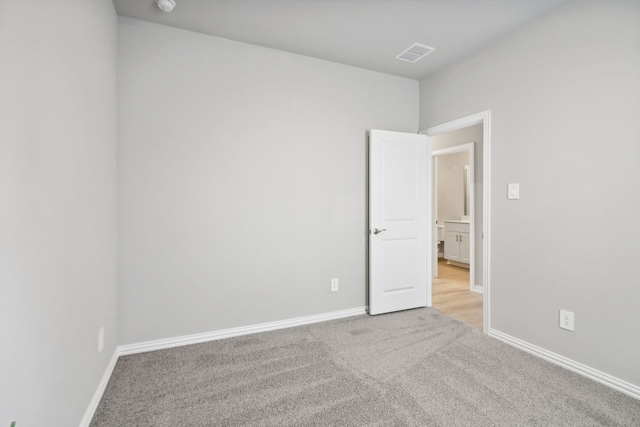 unfurnished room with light carpet