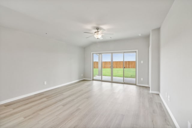 unfurnished room with ceiling fan, light wood-type flooring, and vaulted ceiling