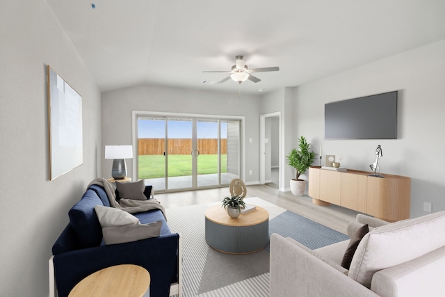 living room featuring ceiling fan, lofted ceiling, and light wood-type flooring