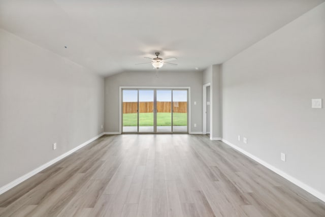 unfurnished room with ceiling fan, vaulted ceiling, and light wood-type flooring