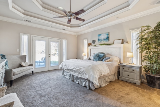 bedroom featuring access to outside, ceiling fan, a tray ceiling, and ornamental molding