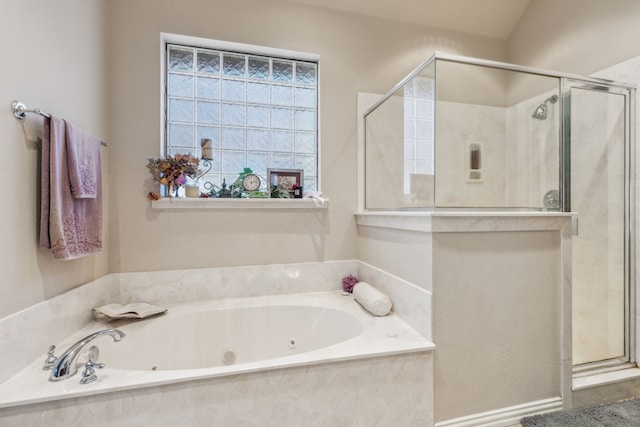 bathroom featuring independent shower and bath