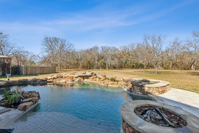 view of pool featuring a fire pit, a yard, and an in ground hot tub