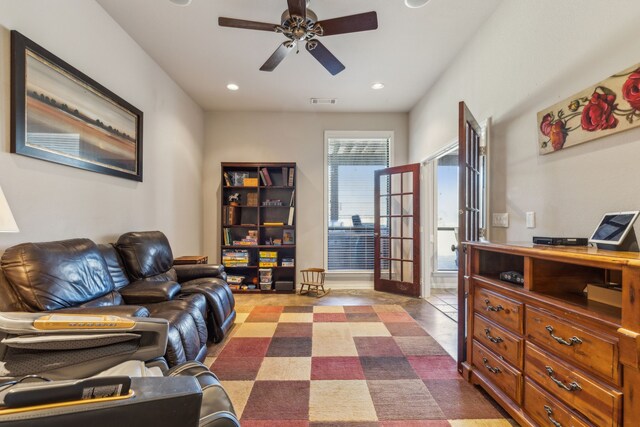 living room featuring french doors, tile patterned floors, and ceiling fan