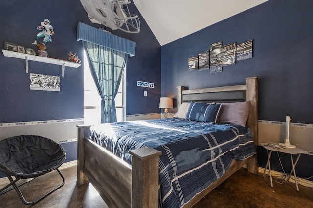 bedroom with lofted ceiling and concrete flooring