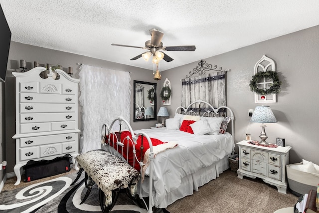 carpeted bedroom featuring a textured ceiling and ceiling fan