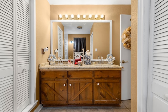 bathroom with tile patterned floors and vanity