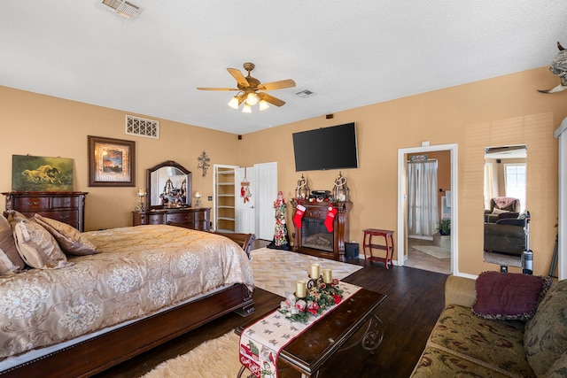 bedroom featuring ensuite bath, ceiling fan, and wood-type flooring