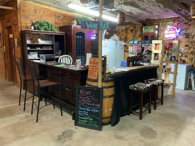 bar with white refrigerator with ice dispenser