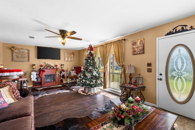 living room with hardwood / wood-style flooring and ceiling fan