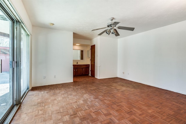 unfurnished room featuring ceiling fan and parquet floors