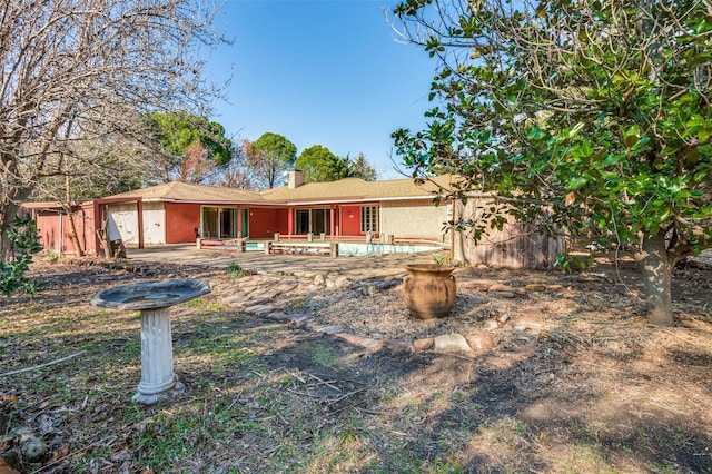 view of front of home with a patio and a garage