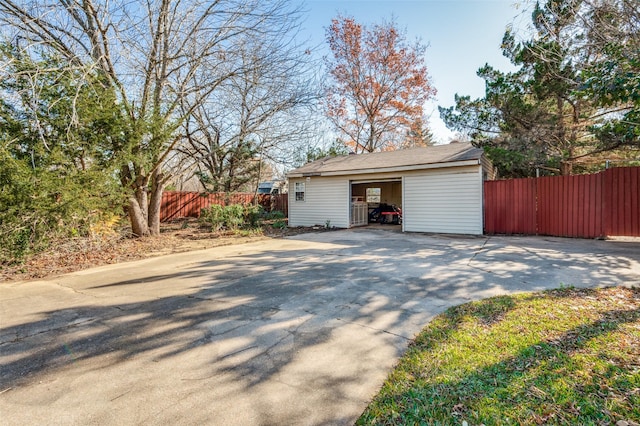 view of property exterior with a garage and an outdoor structure