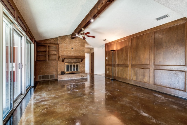 unfurnished living room with vaulted ceiling with beams, a fireplace, and a textured ceiling