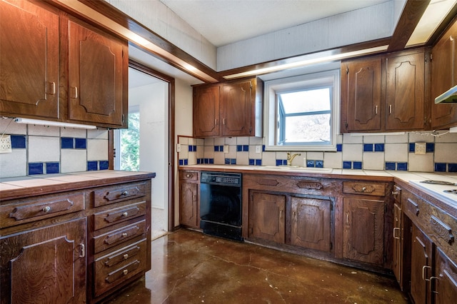 kitchen with dishwasher, decorative backsplash, tile counters, and sink