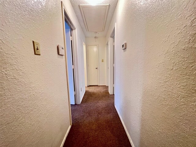 corridor featuring dark carpet